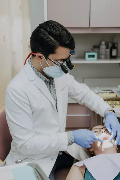 Dr. Talluri looking at a patient's teeth