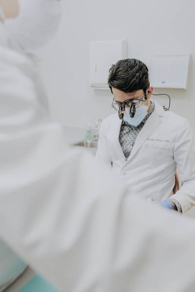 Dr. Talluri installing a dental crown in a patient's smile
