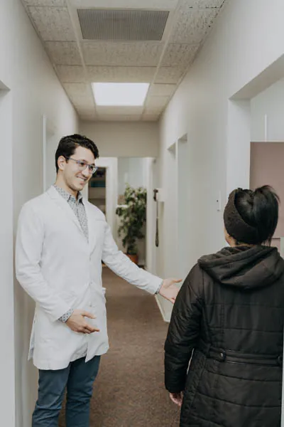 Dr. Talluri showing a patient to the dental exam room at Exquisite Dentistry