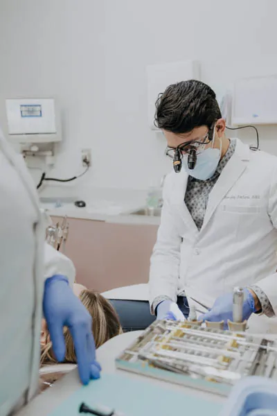 Dr. Talluri taking a look at a patient's teeth