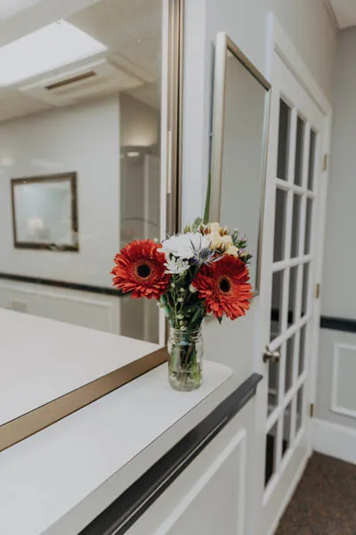 flowers sitting inside the waiting room of Exquisite Dentistry