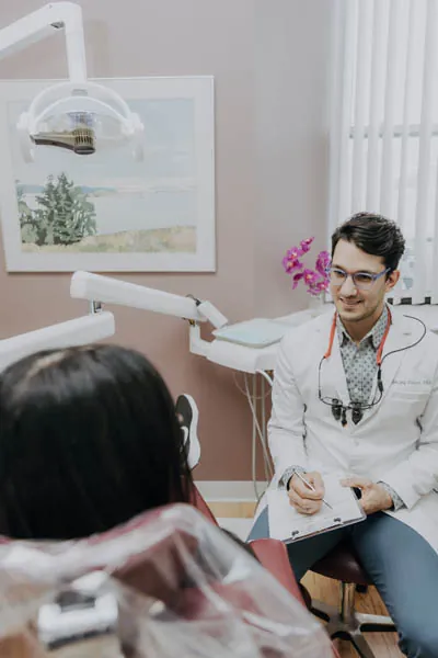 Dr. Talluri talking with a dental patient 