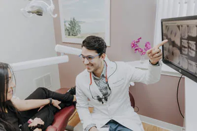 Dr. Talluri showing a dental patient their x-rays