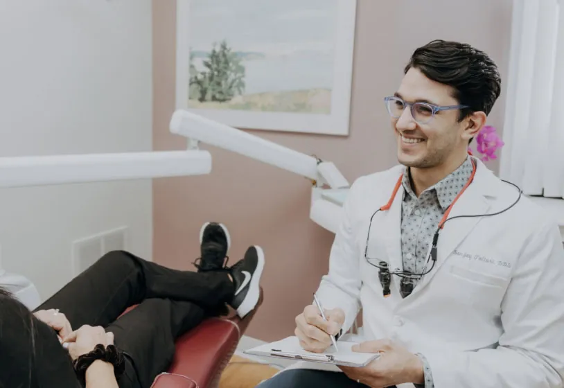 Dr. Sanjay Talluri of Melrose, MA talking with a patient about dental care