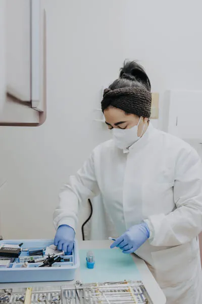 Exquisite Dentistry hygienist preparing a teeth whitening kit for a patient